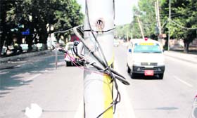 Uncovered wires hang from an electric pole at Lajpat Nagar in Jalandhar