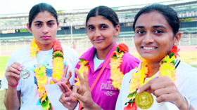 Girls show medals they won in the 100-meter sprint.