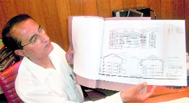 Deputy Commissioner BM Nanta shows the design of Dasehra Sadan to be built in Kullu.