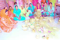 Women display bamboo articles at a workshop in Kharwad