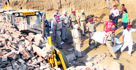 Cops take away the body of Balwinder Kumar from the site of the mishap in Jalandhar on Tuesday.