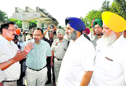 Deputy Chief Minister Sukhbir Singh Badal talks to an official at the expressway along the Sidhwan canal in Ludhiana on Monday