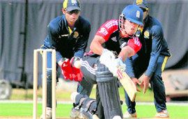 Englands Craig Kieswetter sweeps during a warm-up match with HCA XI in Hyderabad on Tuesday.