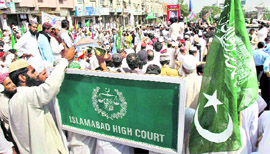 Supporters of Mumtaz Qadri rally outside the Islamabad High Court on Tuesday.