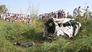 Mangled remains of a car that collided with a train at an unmanned railway crossing near the Khokhar village at Mansa on Wednesday. 