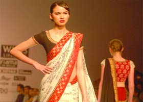 Models display creations by designer Joy Mitra on Wednesday, the last day of the Wills Lifestyle India Fashion Week Spring Summer 2012 collection at Pragati Maidan in New Delhi