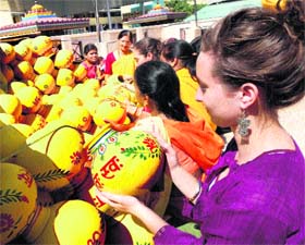 A foreigner looks at a kalash at Shantikunj in Haridwar