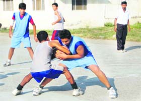 A match under way in the District Basketball Tournament held at the Parade Ground in Dehradun on Wednesday