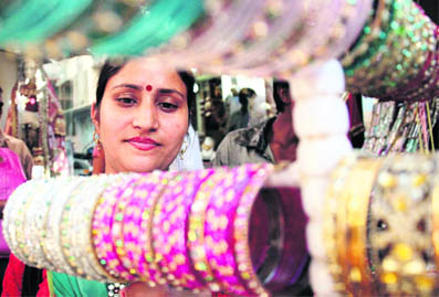 A woman buys bangles ahead of Karva Chauth at Patel Bazaar in Jammu on Wednesday. 
