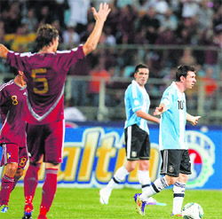 Argentina's Lionel Messi (R) leaves the field as Venezuela's Fernando Amorebieta (L) celebrates at the end of their World Cup 2014 qualifying match in Puerto La Cruz on Wednesday