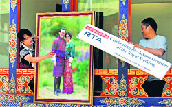 Bhutanese workers place a picture of King Jigme Namagyal Wangchuck