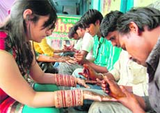 Mehendi artists do brisk business before Karva Chauth in Amritsar.