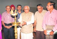 Dr Swatanter Kumar, Vice Chancellor, Gurukul Kangri, Haridwar, lights a lamp during the seminar in Amritsar on Thursday 
