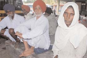 The wife of the deceased inmate Gurdev Kaur (extreme right) sitting outside the mortuary of the Bathinda Civil Hospital on Thursday