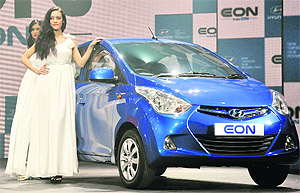 Models pose with the new Hyundai Eon at its launch in Gurgaon on Thursday. The 814cc petrol engine car is claimed to have a fuel mileage of 21.1 km/litre.