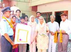 Master Warrant Officer Daljit Khokhar with his family members at Kamal Colony here after receiving the award