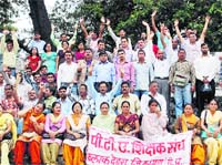 PTA teachers hold a demonstration at Dharamsala on Thursday.