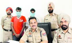 ACP Naresh Dogra along with the two snatchers at the Navi Baradari police station in Jalandhar on Thursday. 
