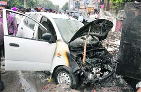 A car which caught fire after garbage lying near it was set a fire on the Mall Road in Ludhiana on Thursday