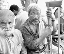 Physically challanged persons wait to get their names registered for disability certificates at the Civil Hospital, Sohana, in Gurgaon