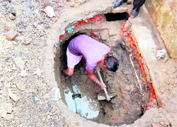 An MC employee repairing a pipeline in the Indra Colony in Amritsar following a threat of jaundice in the area on Friday