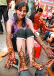 A girl shows the henna designs crafted especially for the Karva Chauth festival in Dhobi Bazaar