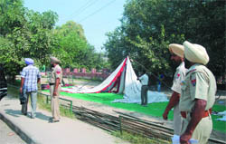 Cops getting the tent of the striking Farad Kendra employees removed from the dharna site outside the Mini-secretariat in Bathinda