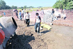Construction of a road in progress near the demolished boundary wall at the Dadu Majra Garbage Plant dumping ground in Chandigarh on Friday. 