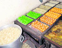 Sweets lying uncovered in unhygienic conditions at New Vaishno Sweets at Sector 8 in Chandigarh on Friday. 