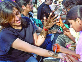 Women get mehndi designs on their hands ahead of the Karva Chauth festival in New Delhi on Friday. 