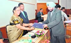Governor Margaret Alva awards a certificate to a participant in a mid-term course at the Lal Bahadur Shastri National Academy of Administration at Mussoorie on Friday.