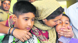 Kartik and Dhruv with their mother at the police station in Jammu.