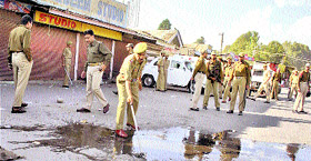 Police officials inspect the spot where the constable was shot at on Friday.