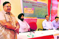 Senior divisional manager of the Life Insurance Corporation SK Aggarval addresses the gathering after inaugrating a satellite office in Ludhiana on Friday