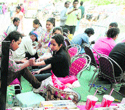 Women get Mehndi applied on their palms at Sarabha Nagar in Ludhiana on Friday