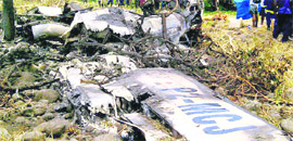 Locals gather at the crash site of an Airlines PNG Dash 8 plane near Madang in Papua New Guinea on Friday.