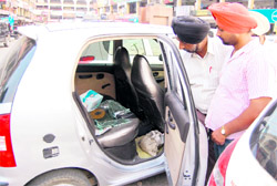 Victims show broken windowpanes of their car in Amritsar on Saturday