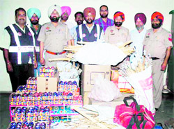 CIA staff pose for a picture along with the seized firecrackers from an illegal firecracker unit at Anngarh area in Amritsar on Saturday