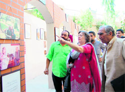 Moneeza Hashmi, daughter of Faiz Ahmed Faiz, looks at photographs of his father depicting his career in an exhibition on the ace Urdu poet at the Punjab Naatshala in Amritsar on Saturday