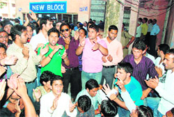 Students hold a demonstration in protest against alleged irregularities in the law entrance test in DAV College in Dehradun on Saturday