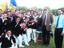 Major-Gen Tejwant Singh Gill, Deputy Commandant and Chief Instructor, Indian Military Academy (wearing a cap), after presenting the athletics trophy to the Shivaji section of Rashtriya Indian Military College 