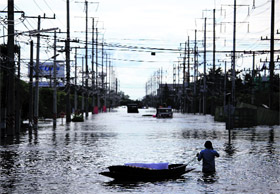A man wades through a flooded estate in Ayutthaya province near Bangkok on Saturday. 