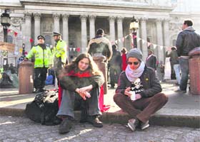 Demonstrators sit outside St Paul's Cathedral in central London on Sunday