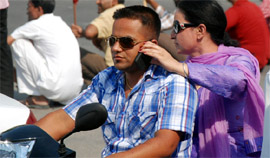 A pillion rider plays a perfect assistant to a biker in Bathinda.