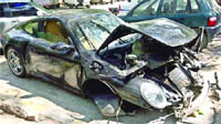 The damaged Porsche Carrera car parked at Tilak Marg police station after it crashed into the wall of Children Park at India Gate in New Delhi on Sunday.