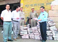 Health officials investigate a store of sweets in Mandi on Sunday. 