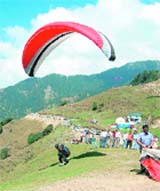 A participant lands during the paragliding championship at Bir Billing in Kangra on Sunday