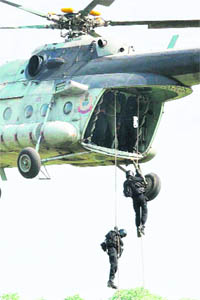 NSG commandos stage a mock drill of a counter-terrorist operation on the occasion of the 27th Raising Day of the National Security Guards on the NSG campus in Manesar, Gurgaon, on Sunday. 