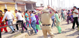 Police personnel dispers agitating teachers on Sunday near Samrala Chowk in Ludhiana.