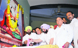 Punjab Congress president Capt Amarinder Singh lights a candle at a function of the Dalit Mahapanchayat in Ludhiana on Sunday.